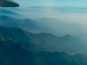 Hills outside Santiago, smog in the valleys, Andes in the far distance